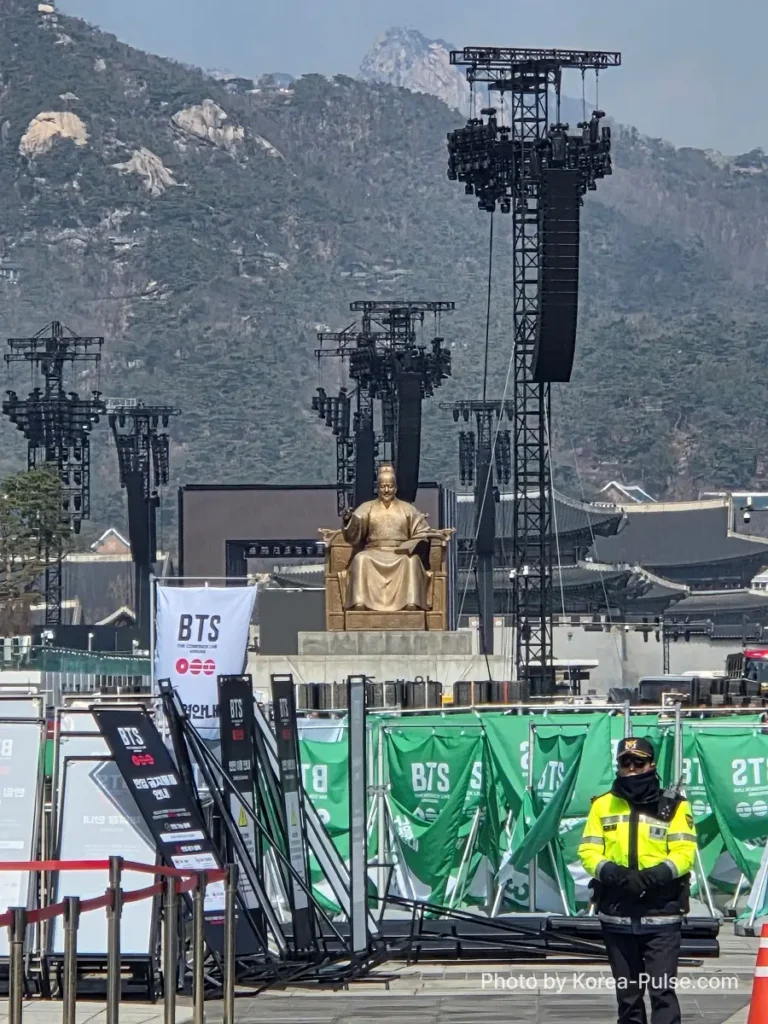 A Policeman is standing in front of BTS Comeback 2026 Seoul show case