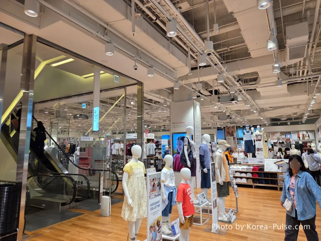 Uniqlo store interior at DUNDUN Dongdaemun 1st floor showing UT graphic tees blazers and full collection