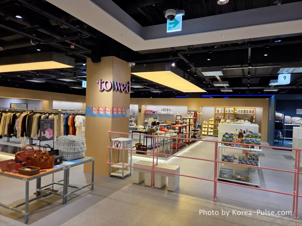 Towed lifestyle and fashion edit shop interior at DUNDUN Dongdaemun 6th floor with pink railing and curated goods