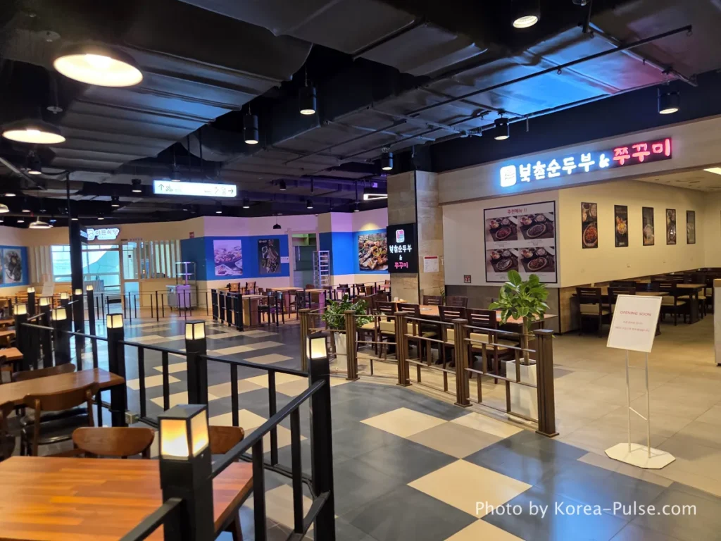8th floor restaurant area and colorful neon claw machine Ppobgi arcade at DUNDUN Dongdaemun Seoul