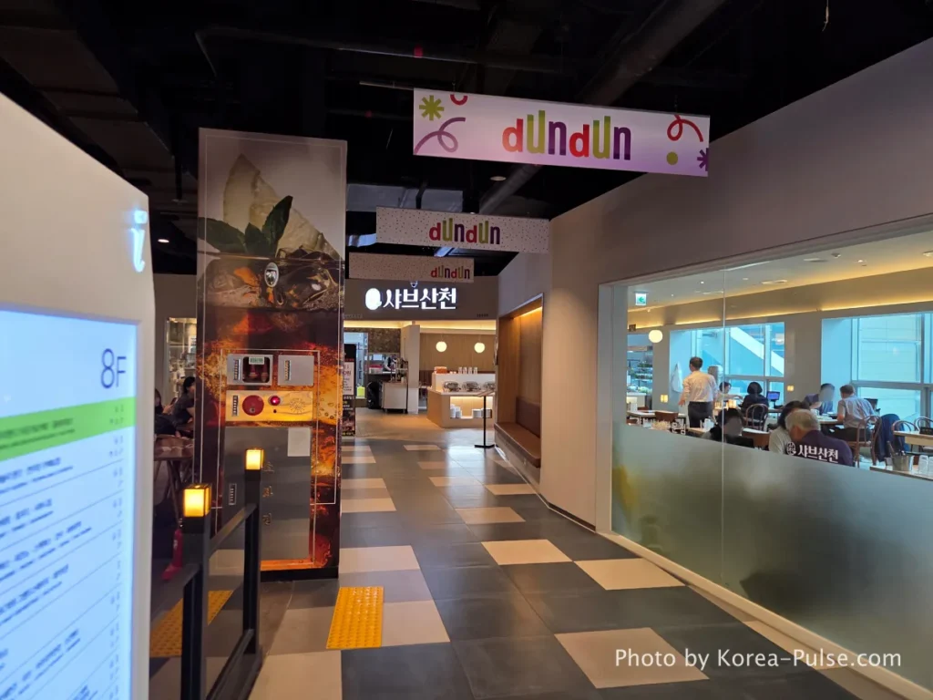8th floor restaurant area and colorful neon claw machine Ppobgi arcade at DUNDUN Dongdaemun Seoul