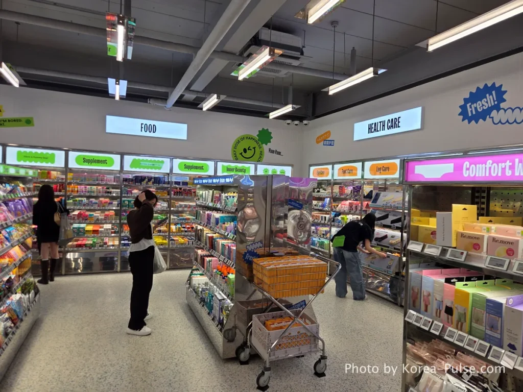 Olive Young Myeongdong Town second floor health and wellness product section with extensive shelving stocked with supplements and functional food items