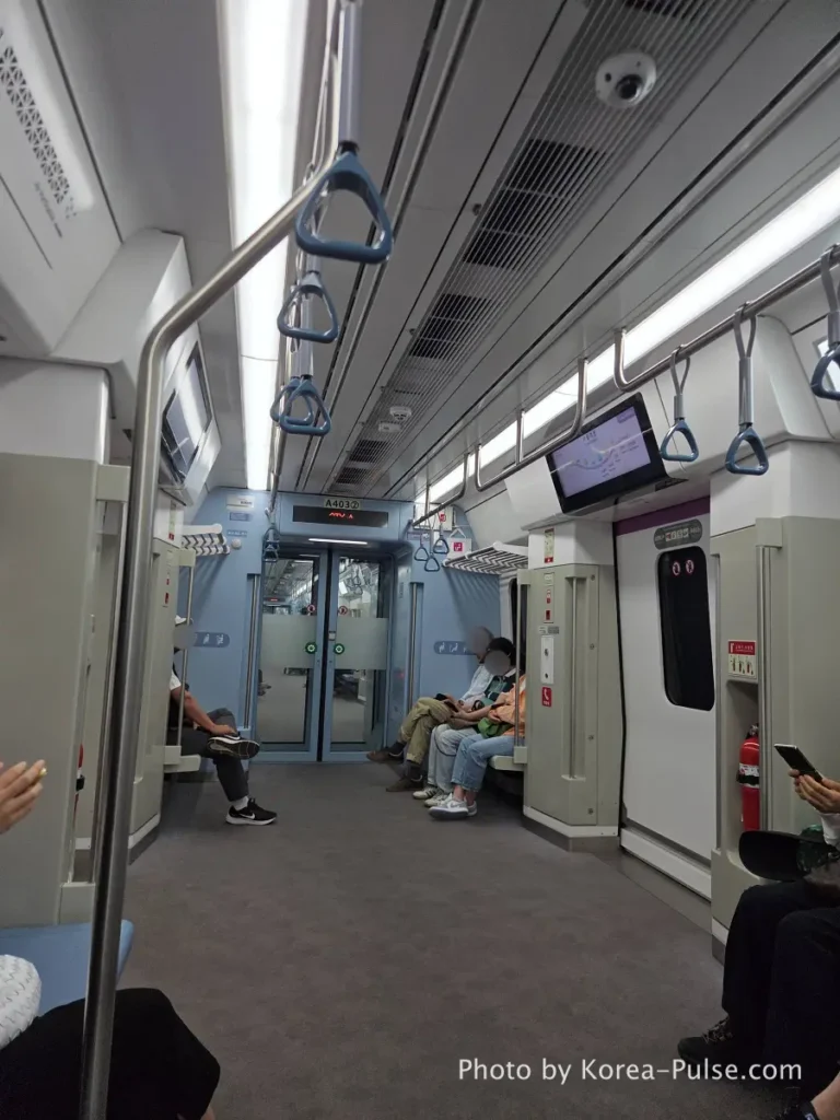 Spacious interior view of the GTX-A express train cabin with comfortable blue handles