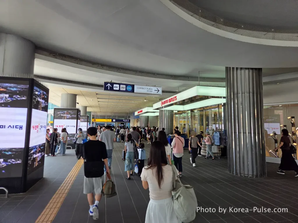 Seoul Station plaza ground level with Lotte Outlets and crowds of weekend travelers