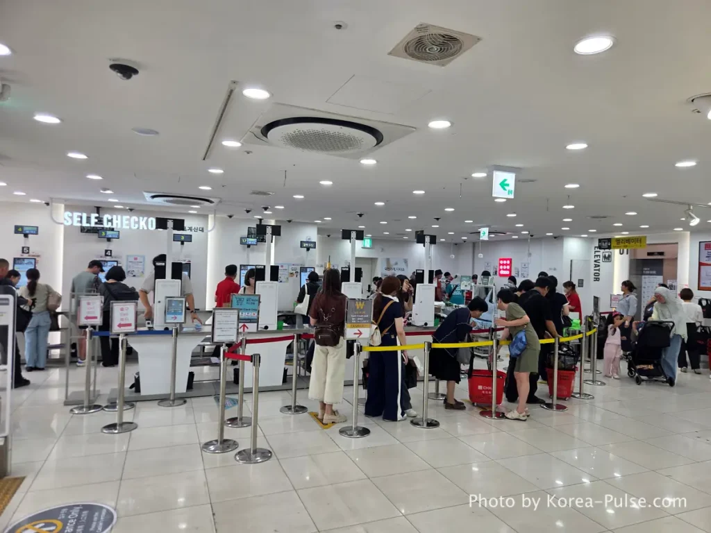 Daiso Myeongdong, Floor by FloorA 12-Story Shopping Survival Guide 3 Daiso Myeongdong Station branch 1st floor checkout counter area crowded with shoppers Seoul