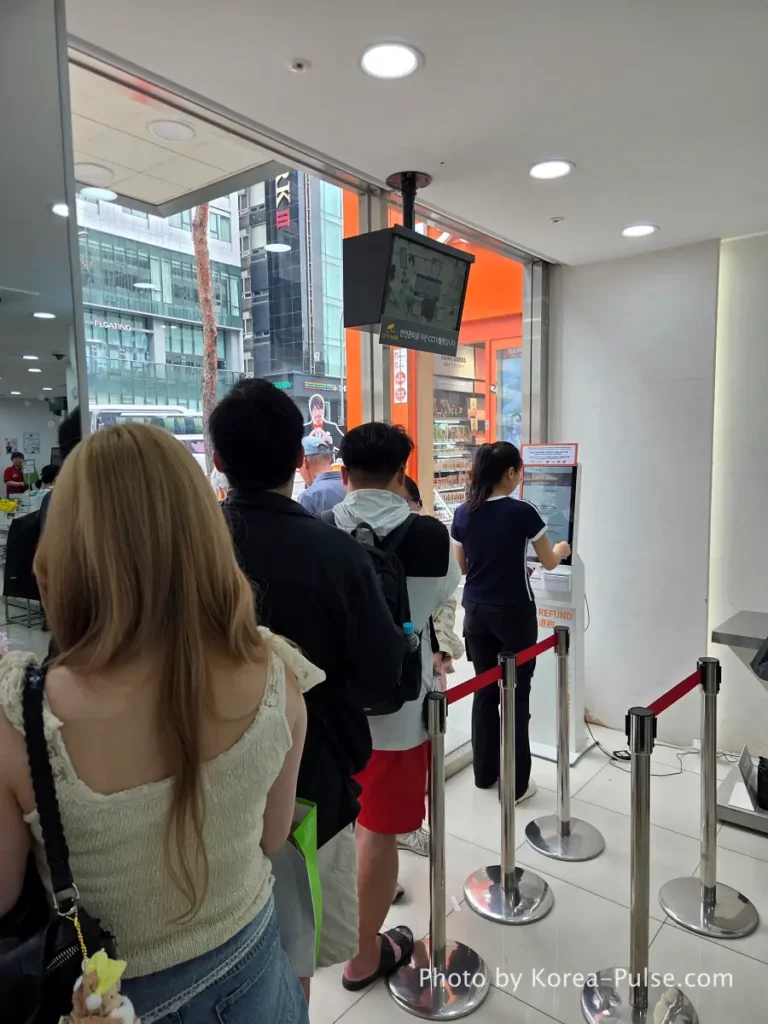 Daiso Myeongdong, Floor by FloorA 12-Story Shopping Survival Guide 37 International tourists waiting in line at tax refund counter on 1st floor Daiso Myeongdong Station branch Seoul