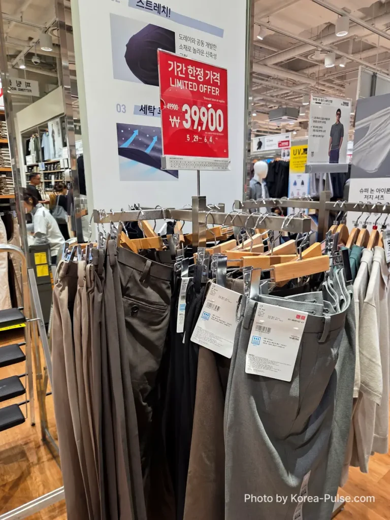 Uniqlo Thank You Festival in Seoul: I Went for One Thing and Bought Another (No Regrets) 3 Rack of men's stretch trousers in the Uniqlo Seoul store with a red Limited Offer sign showing the Gamsaje sale price of 39,900 won, reduced from 49,900 won