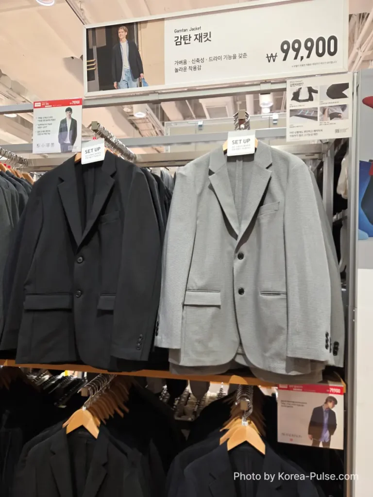 Uniqlo Thank You Festival in Seoul: I Went for One Thing and Bought Another (No Regrets) 5 Uniqlo Gamtan Jacket (감탄 재킷) display showing navy and light grey blazers hanging on a rack with a sale price tag of 79,900 won, reduced from 99,900 won