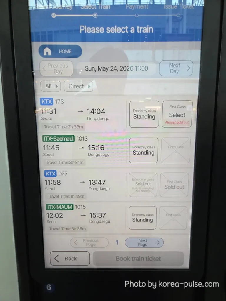 KTX ticket machine screen displaying the Please Select a Train page showing KTX 173 at 11:31 with Economy class Standing and First Class Almost Sold Out, plus other train options below
