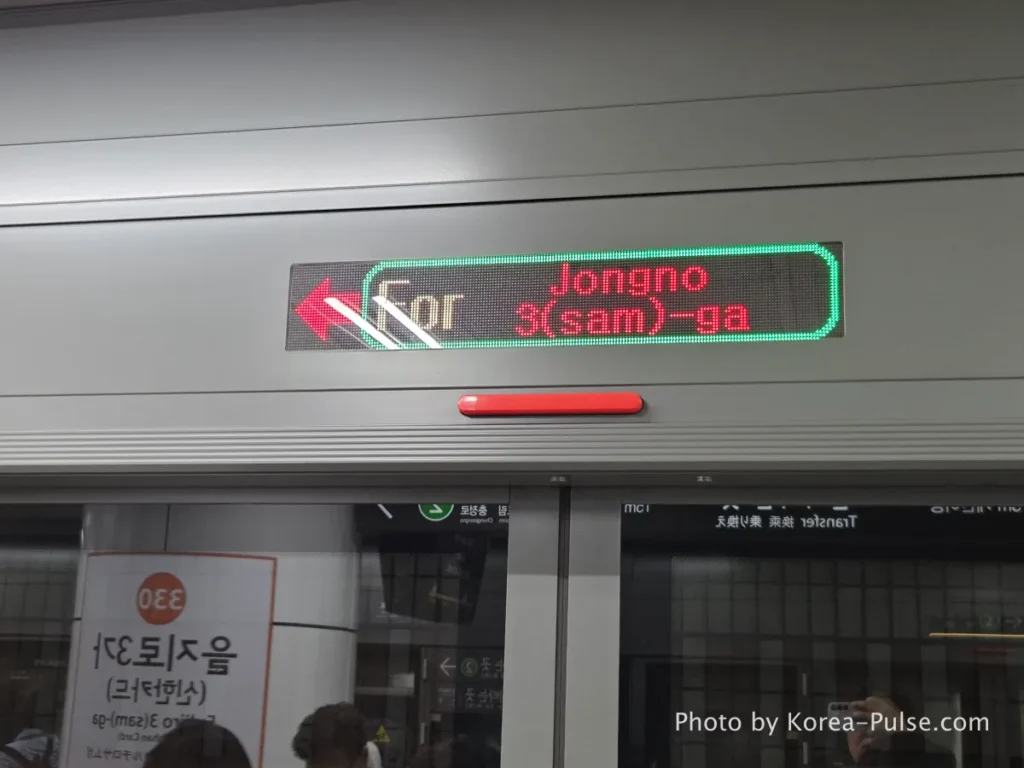 LED destination sign on Seoul Metro displaying "For Jongno 3(sam)-ga" in English with directional arrow
