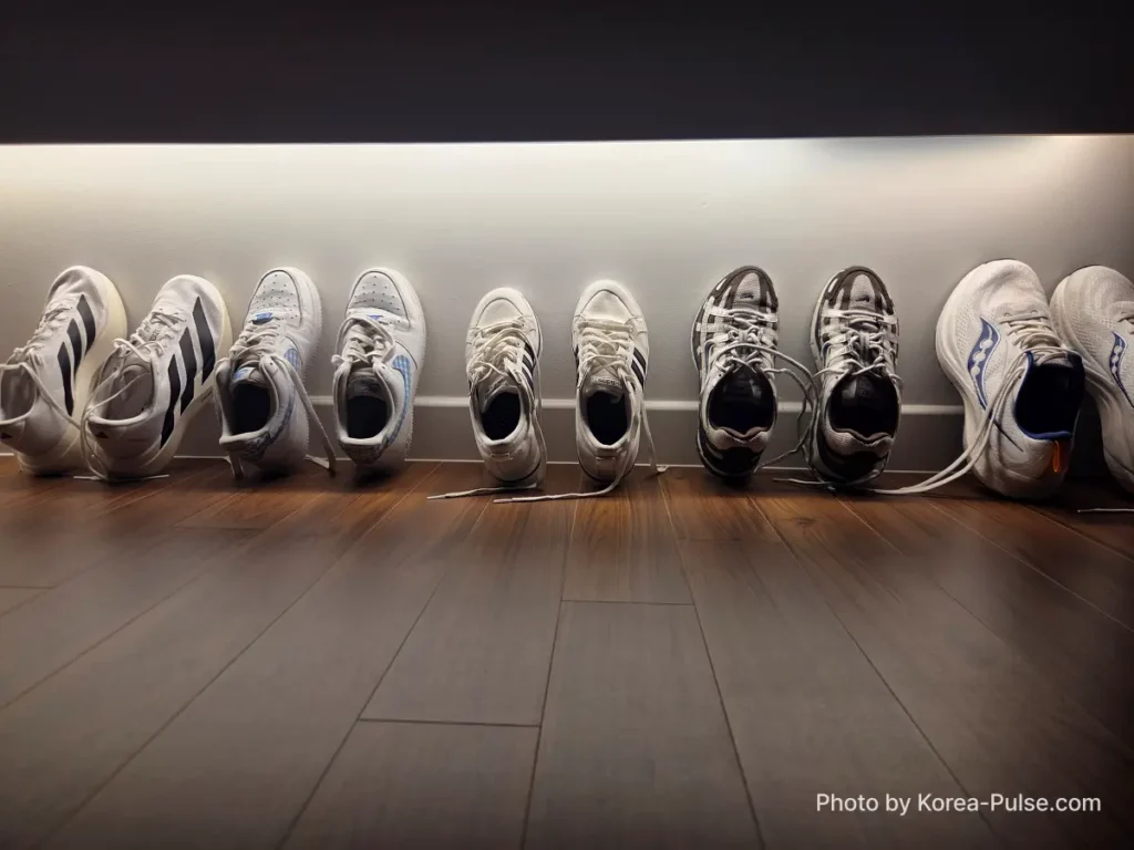 Coin Laundry in Korea: The Local's Complete Guide to 빨래방 18 Five pairs of clean sneakers lined up against wall at home after drying at Korean coin laundry 빨래방 Easy Wash Seoul with tongues open to air dry