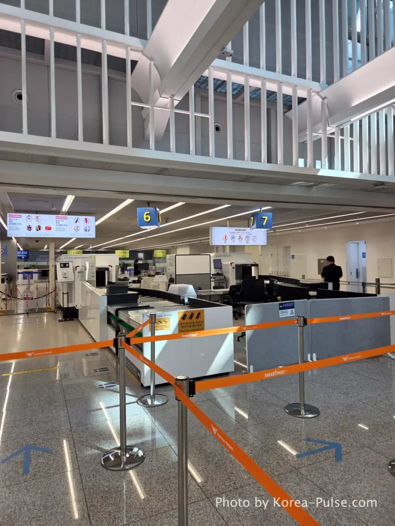 Incheon Airport security baggage screening checkpoint with empty conveyor belts after Smartpass gate entry
