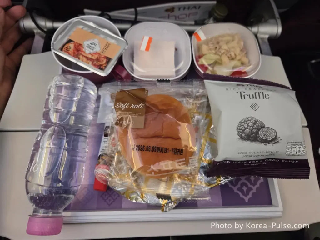Thai Airways in-flight meal tray with warm food and dessert served on Bangkok route