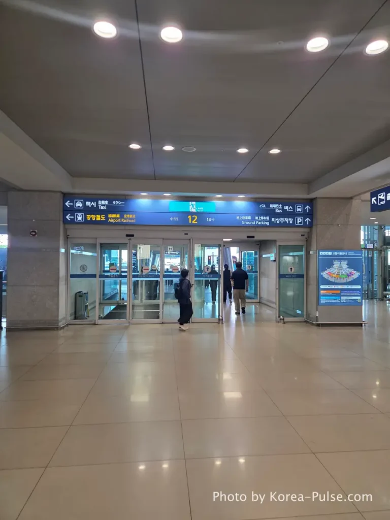 Incheon Airport Arrival Guide: Plane to Bus in Under an Hour 10 Incheon Airport arrival hall Exit Gate 12 sign with direction arrows at Terminal 1