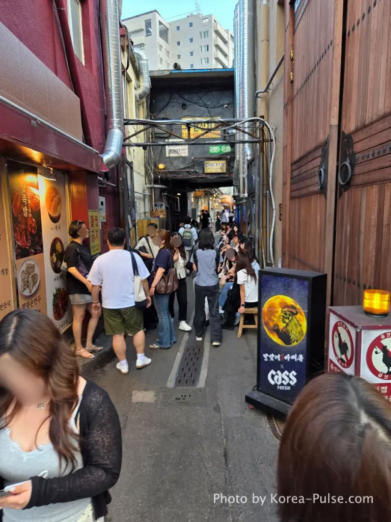 Euljiro outdoor dining Dalmaji Plaza BBQ entrance alley packed with people waiting in line Hipjiro Seoul