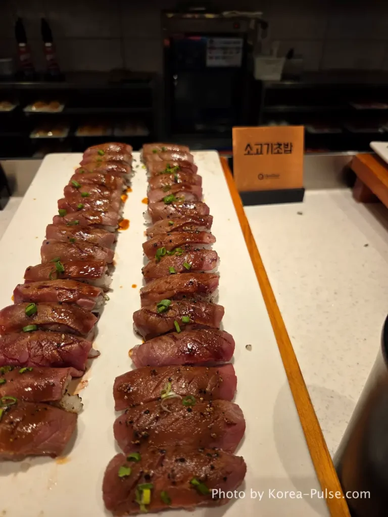 The 120-Dish Question: Inside QooQoo, Korea's Sushi Buffet Phenomenon 12 Beef sushi rows with scallion topping at QooQoo buffet