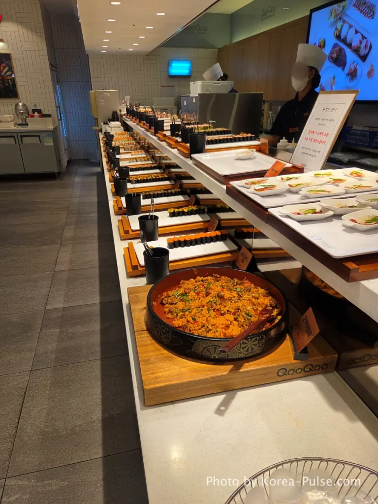 The 120-Dish Question: Inside QooQoo, Korea's Sushi Buffet Phenomenon 13 Gunkan zone and aged sashimi corner along the counter at QooQoo