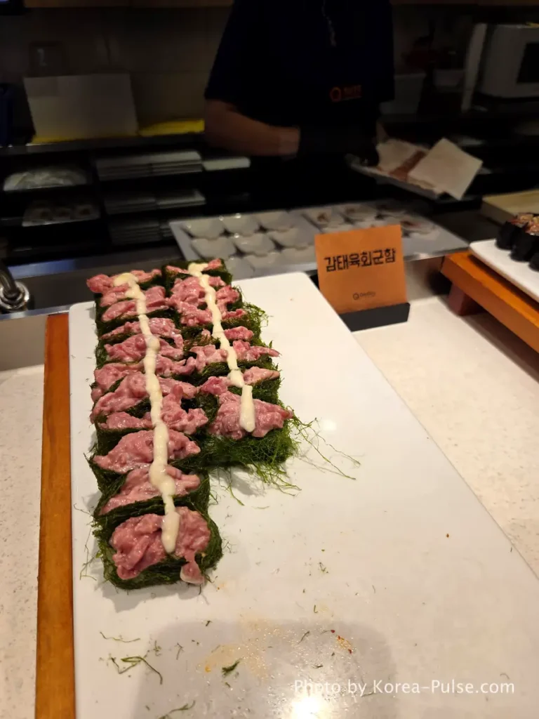 The 120-Dish Question: Inside QooQoo, Korea's Sushi Buffet Phenomenon 15 Gamtae yukhoe gunkan with seasoned raw beef on seaweed at QooQoo