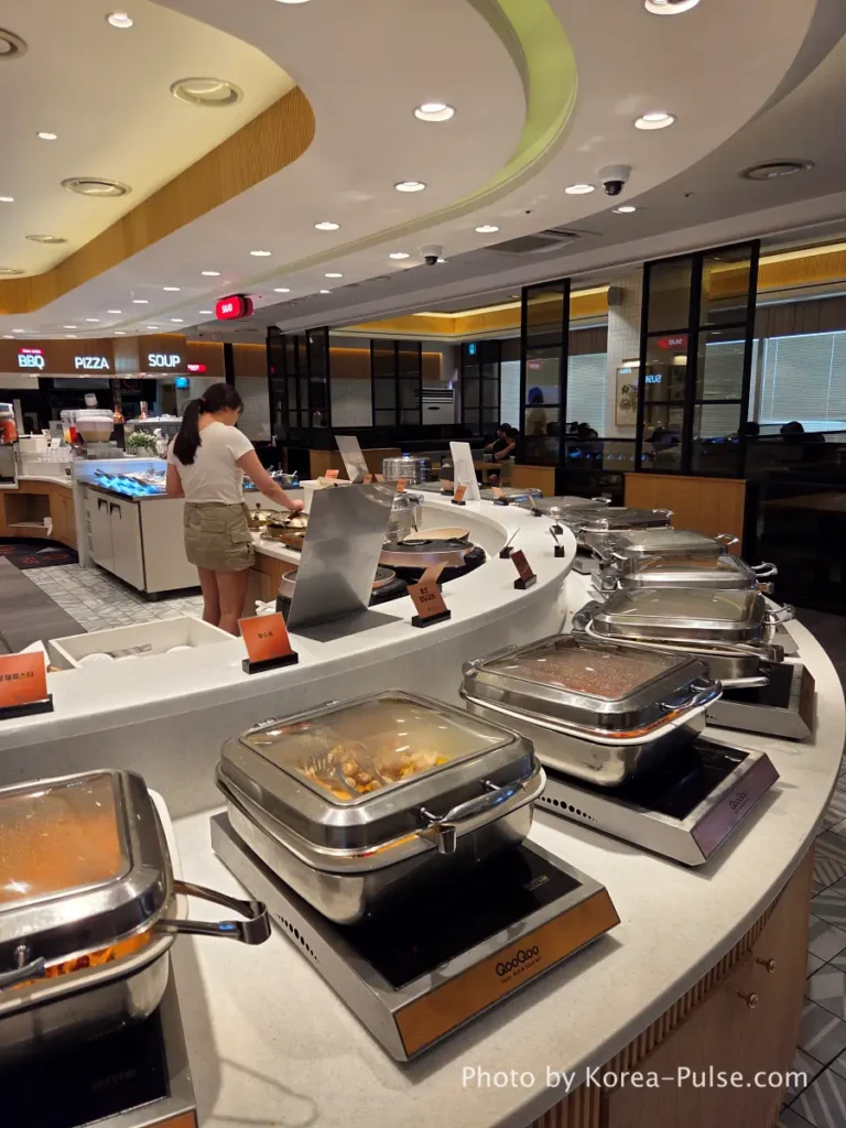 The 120-Dish Question: Inside QooQoo, Korea's Sushi Buffet Phenomenon 6 Center zone right side with tangsuyuk and pasta stations at QooQoo