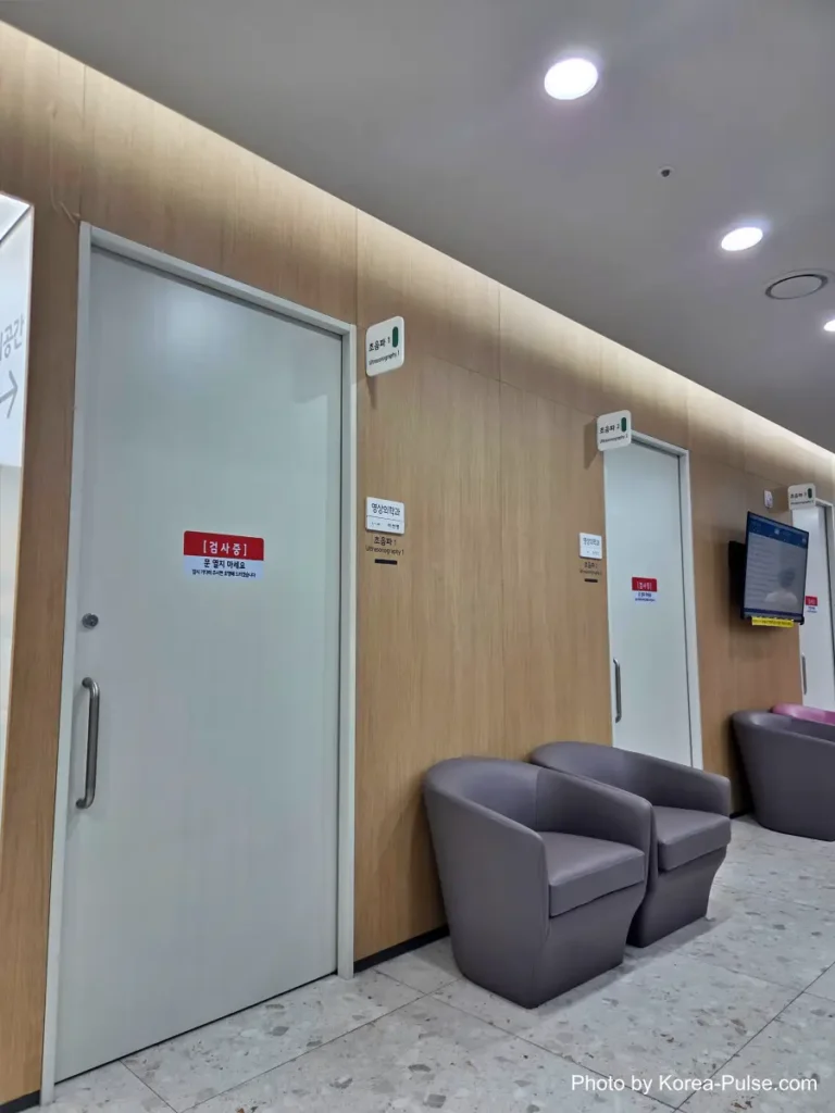 Inside Korea's 2-Hour Health Checkup Machine: Wristbands, Yellow Lines, and a Bowl of Porridge 7 Corridor with a radiation warning sign outside an ultrasound and imaging examination room
