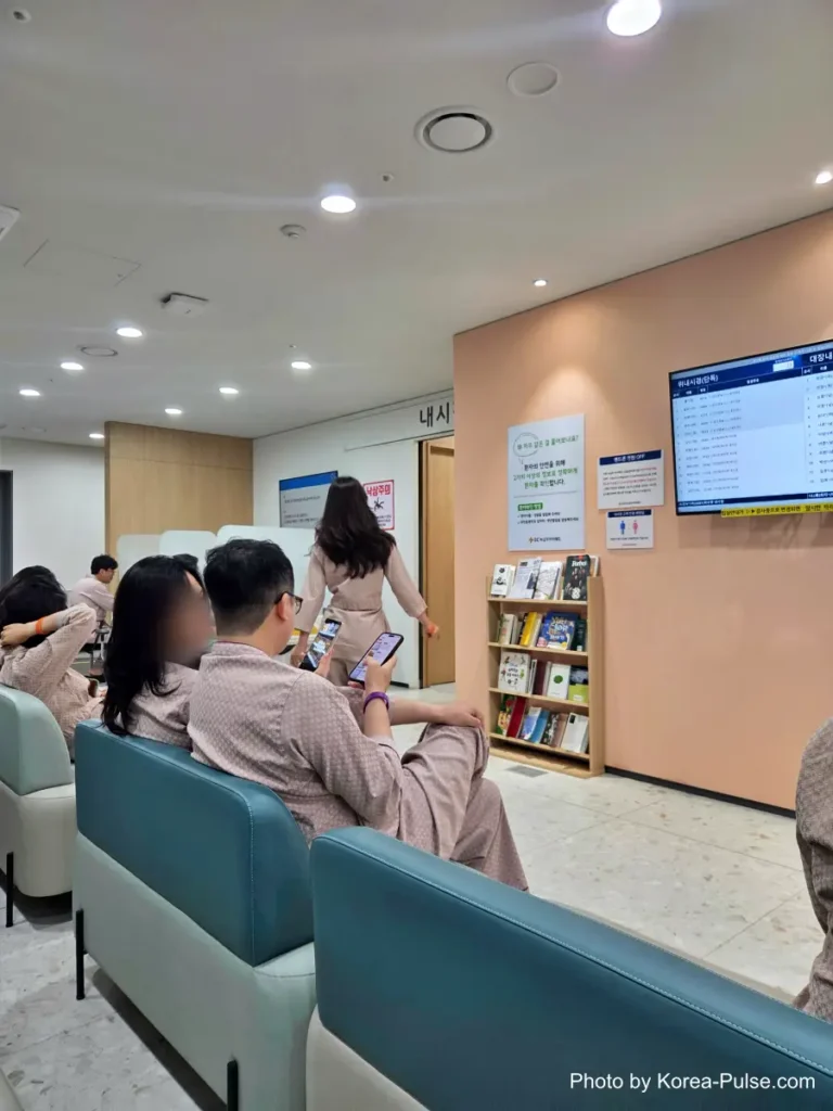 Inside Korea's 2-Hour Health Checkup Machine: Wristbands, Yellow Lines, and a Bowl of Porridge 13 Patients in hospital gowns seated in a waiting room outside the endoscopy department