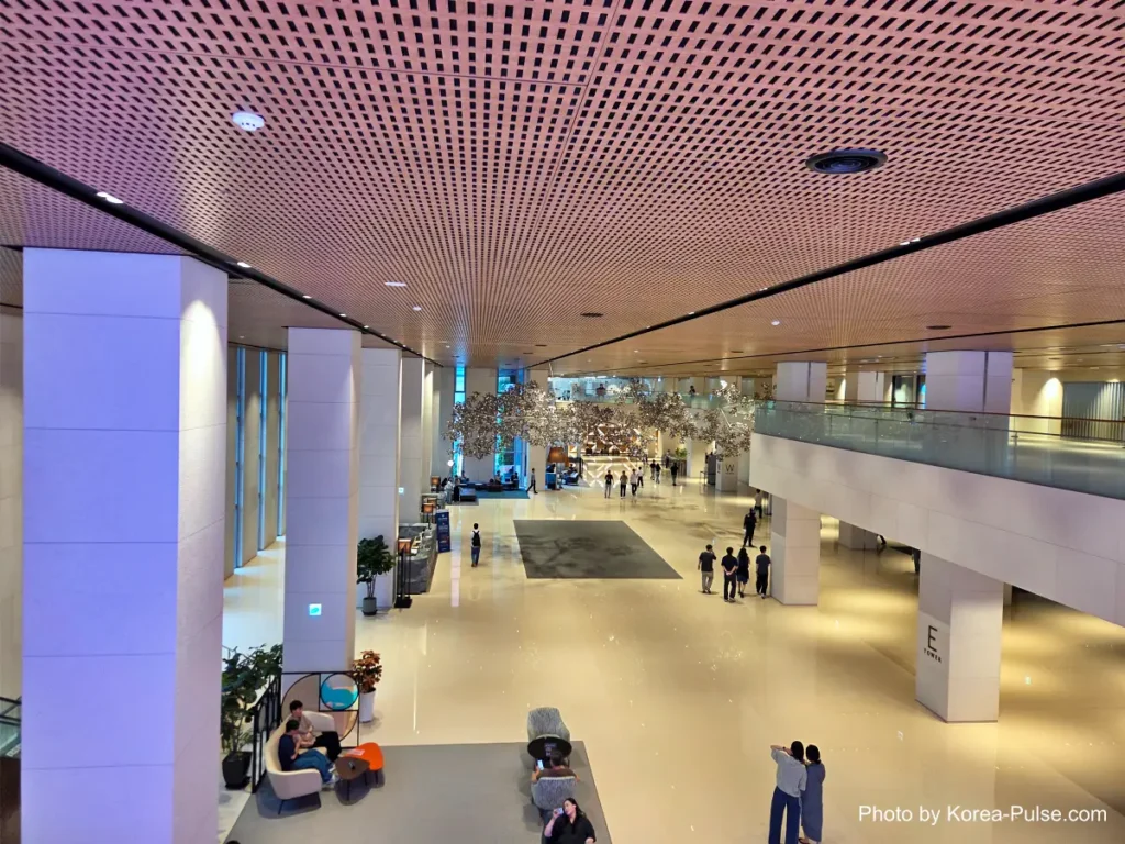 Inside Korea's 2-Hour Health Checkup Machine: Wristbands, Yellow Lines, and a Bowl of Porridge 18 Spacious atrium lobby with people walking through, in the building housing a Seoul health checkup center