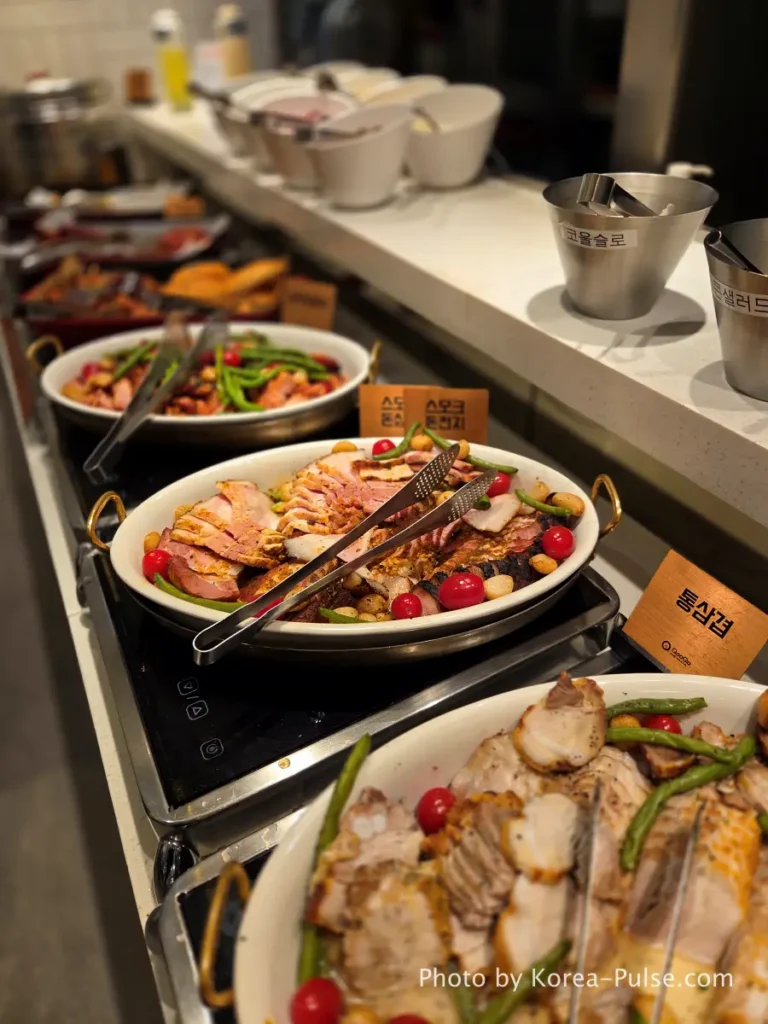 The 120-Dish Question: Inside QooQoo, Korea's Sushi Buffet Phenomenon 9 Smoked pork shoulder and pork belly plated at QooQoo Korean BBQ zone