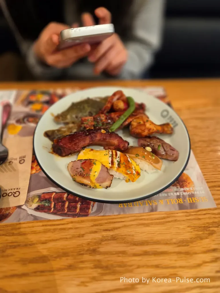 The 120-Dish Question: Inside QooQoo, Korea's Sushi Buffet Phenomenon 21 Daughter's plate with sushi fried chicken and pork ribs at QooQoo