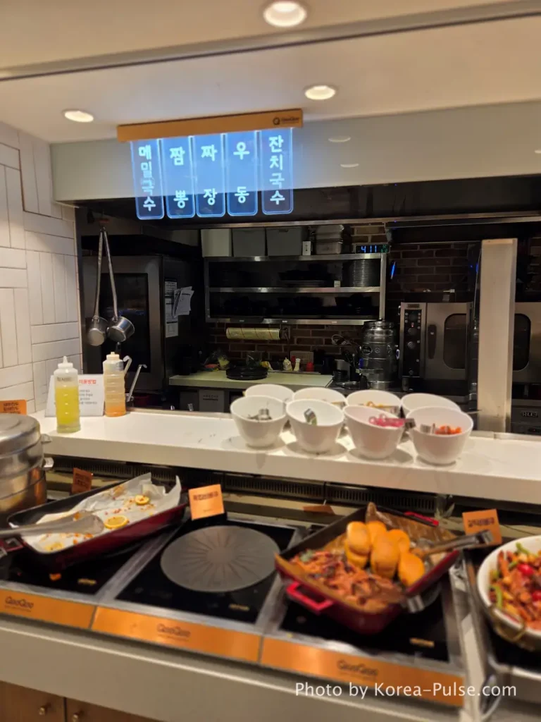 The 120-Dish Question: Inside QooQoo, Korea's Sushi Buffet Phenomenon 22 Noodle station with Korean-only menu signs at QooQoo buffet