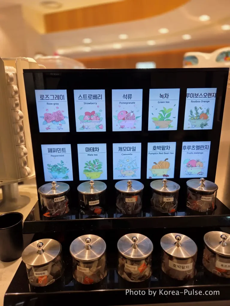 The 120-Dish Question: Inside QooQoo, Korea's Sushi Buffet Phenomenon 23 Tea zone detail with rooibos and herbal tea jars at QooQoo buffet