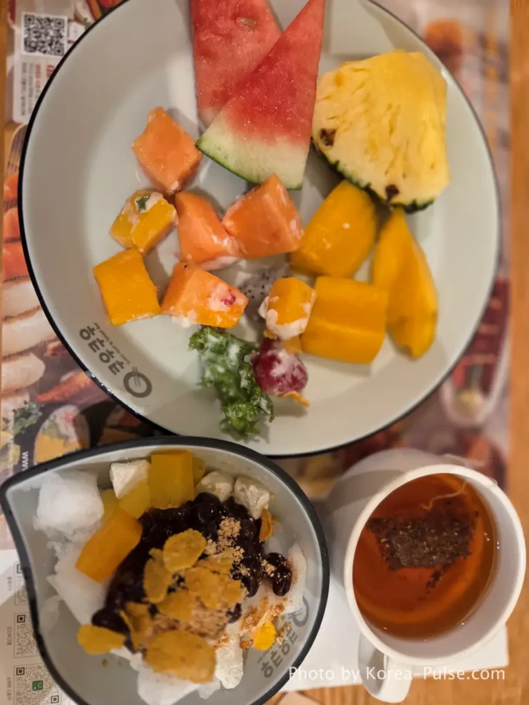 The 120-Dish Question: Inside QooQoo, Korea's Sushi Buffet Phenomenon 26 Final dessert plate with watermelon pineapple mango and patbingsu at QooQoo
